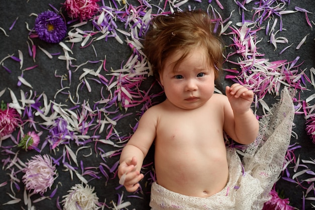 Ritratto di una piccola bambina dolce con una corona di fiori