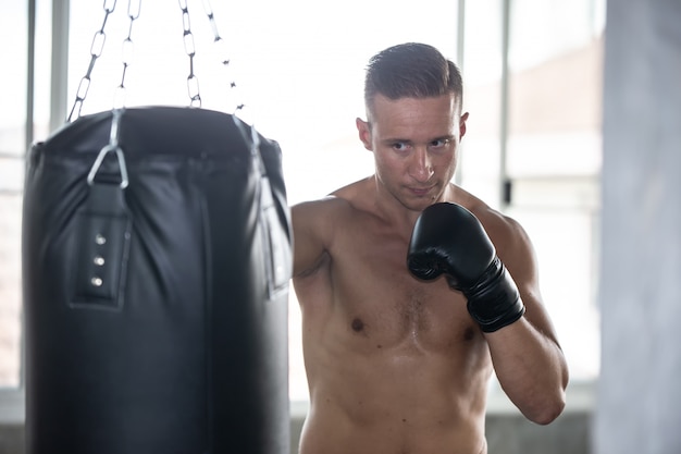 ritratto di uomo con guantoni da boxe in palestra