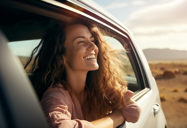 Ritratto fotografico di una donna che sporge dal finestrino dell'auto mentre guida un'auto nella natura estiva