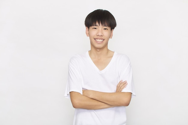 Ritratto Young Asian Teenager studente maschio che indossa una camicia bianca con le braccia piegate su sfondo bianco