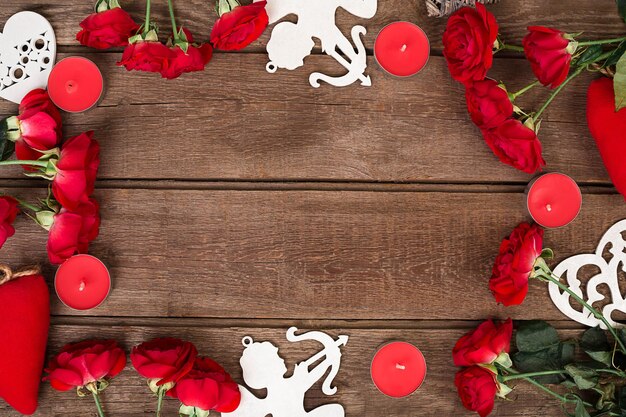 Rose rosse candele e cuori su legno con copia spazio San Valentino sfondo