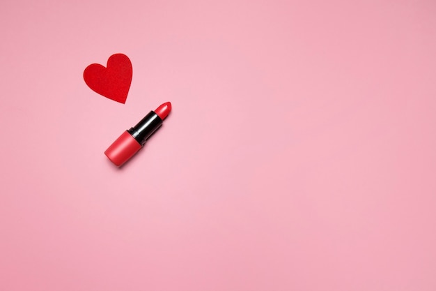 rossetto e piccolo cuore su sfondo rosa