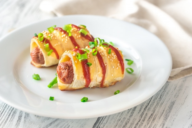 Rotoli di salsiccia sul piatto bianco