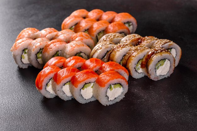 Rotoli di sushi belli freschi deliziosi su uno sfondo scuro