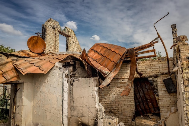 Rovine di una casa privata. Casa bruciata. Una parabola satellitare arrugginita. Vita rovinata. Resti dell'edificio.