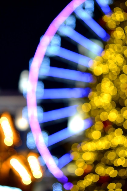 Ruota panoramica decorata illuminazione blu e grande albero di Natale