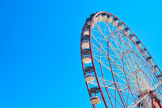 Ruota panoramica rossa contro il cielo blu.