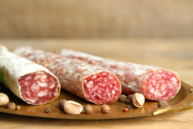 Salame italiano su vassoio su sfondo di legno