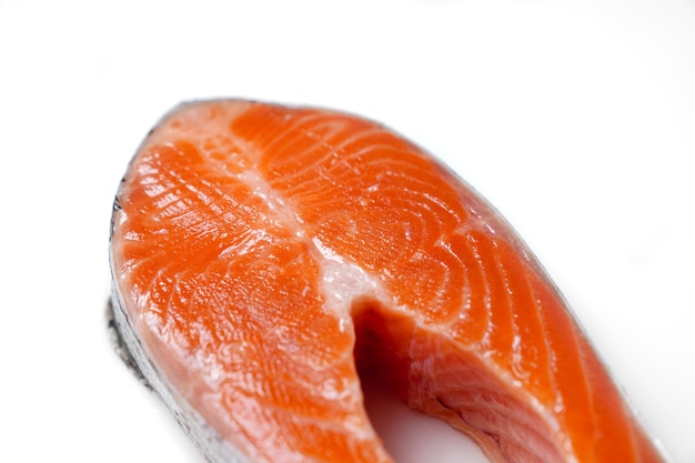 Salmone affettato a pezzi su sfondo bianco. pesce rosso. trota fresca per cucinare.