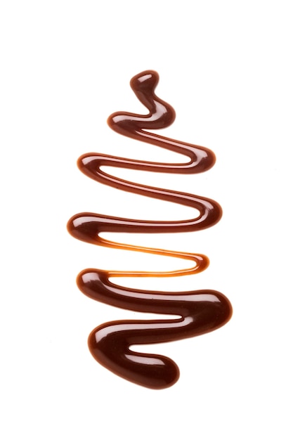 Salsa al caramello al cioccolato si increspa su un semplice fondo bianco