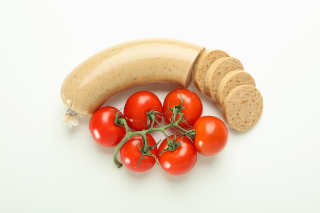 Salsiccia di fegato e pomodori su sfondo bianco vista dall'alto