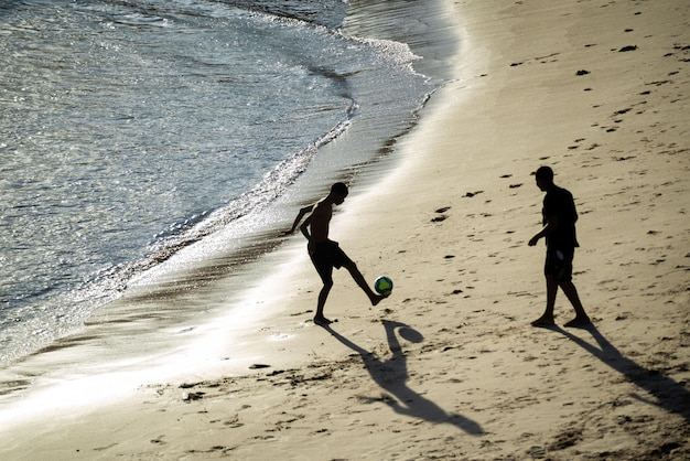 Salvador Bahia Brasile 01 novembre 2021 Due giovani che giocano a beach soccer sulla spiaggia di Rio Vermelho a Salvador Bahia nel tardo pomeriggio