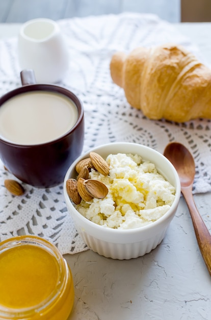 Sana colazione con ricotta o ricotta con mandorle noci, miele e tazza di caffè