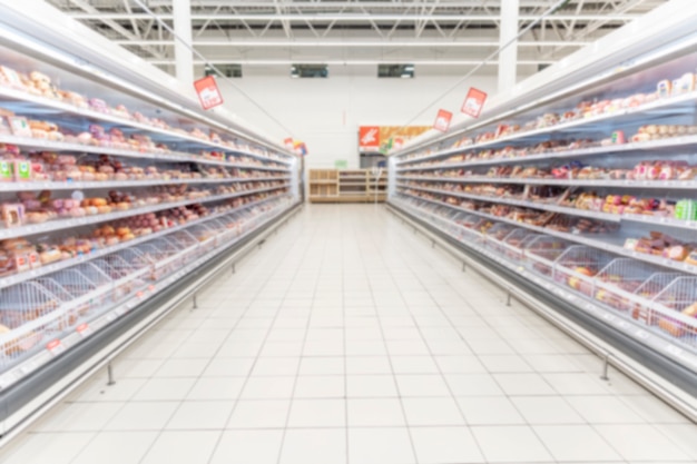 Scaffali con cibo freddo in un supermercato. Spazio per il testo. Sfocato.