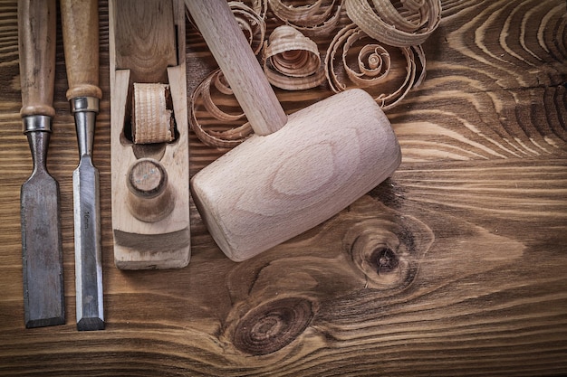 Scalpelli per la rasatura di trucioli piani maglio di legno su tavola di legno concetto di costruzione.