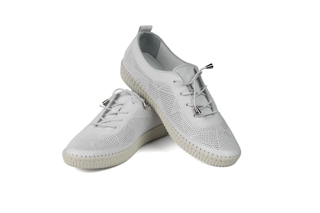 Scarpe bianche in pelle realizzate in pelle traforata isolate su fondo bianco. Minimo concetto di bellezza e sport.