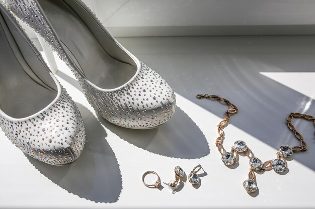 Scarpe da sposa con cristalli di diamante Profumi e accessori per orecchini Il giorno del matrimonio foto in bianco e nero