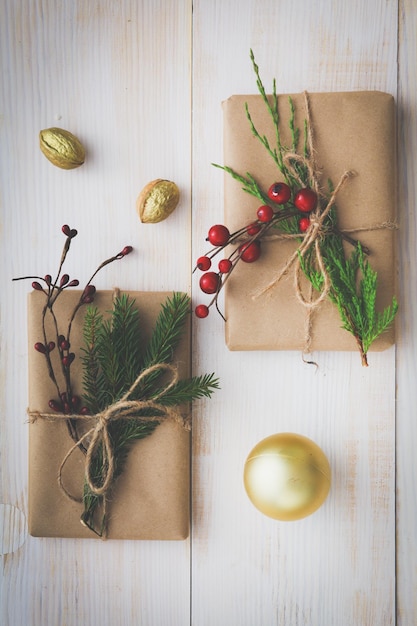 Scatole regalo di Natale e ramo di abete su tavola di legno piatto sullo sfondo di Shristmas