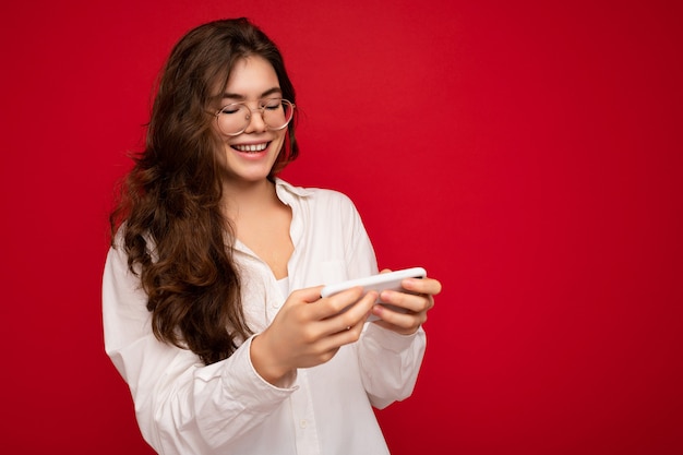 Scatto fotografico di una giovane donna attraente e positiva che indossa abiti casual ed eleganti in bilico