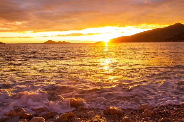 Scenic tramonto colorato in riva al mare.