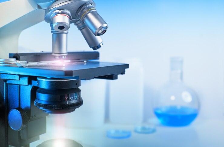Scientific  with closeup on light microscope and laboratory out of focus