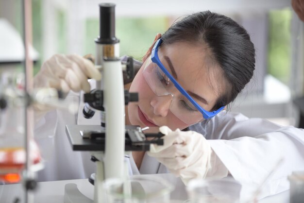 Scienziata che usa il microscopio in laboratorio