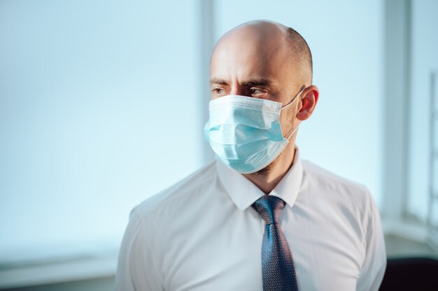 scienziato in una maschera protettiva sullo sfondo di un laboratorio medico