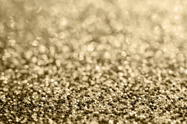 Scintillio dorato astratto scintillante sfocato con sfondo bokeh