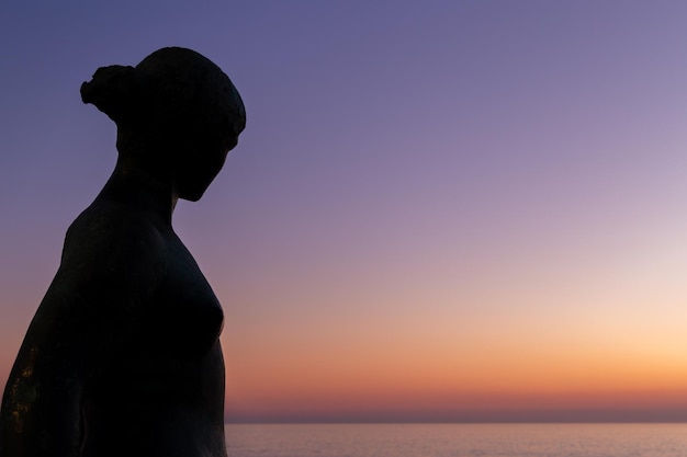 Scultura di una donna al tramonto