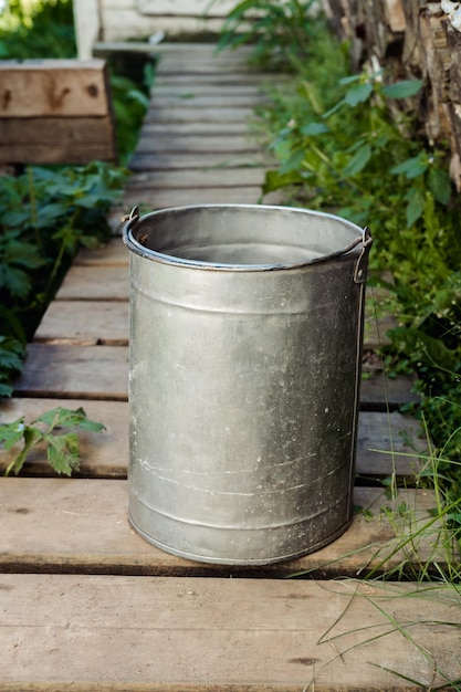 Secchio di ferro con acqua in campagna in estate