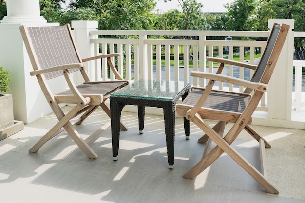 Sedie in legno sul balcone moderno che si affaccia su un giardino