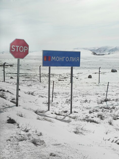 Segno che segna il passaggio del confine con la Mongolia Il confine è su un pendio innevato della montagna