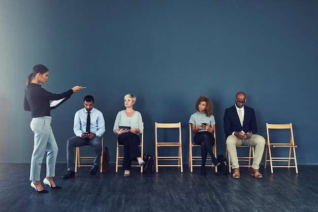 Sei qui dopo Inquadratura di una donna che indica uno dei candidati in attesa di essere intervistato