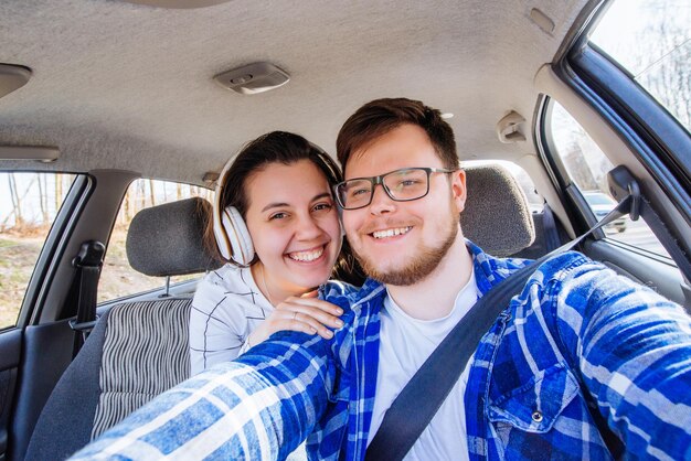 Selfie di concetto di viaggio in auto di guida delle coppie