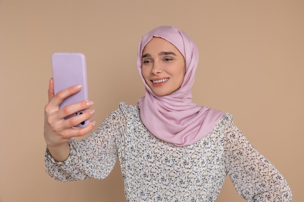 Selfie Donna carina che si fa un selfie con la telecamera del telefono e sorride