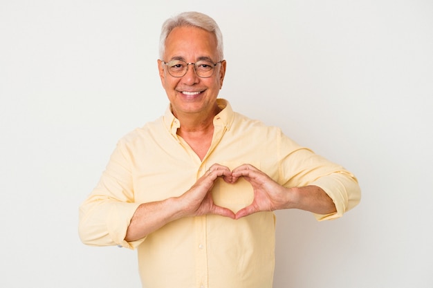 Senior uomo americano isolato su sfondo bianco sorridente e mostrando una forma di cuore con le mani.