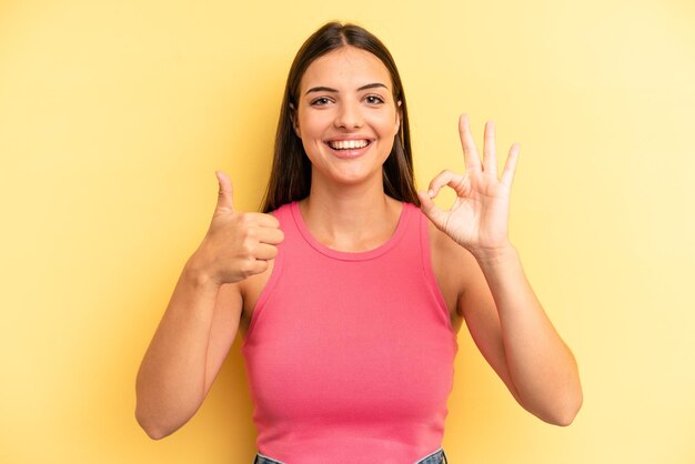 Sentendosi felice stupito soddisfatto e sorpreso mostrando gesti ok e pollice in alto sorridendo