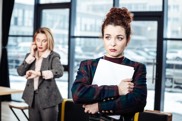 Senza offerta di lavoro. Giovane tirocinante riccio dai capelli scuri che lascia l'azienda senza offerta di lavoro