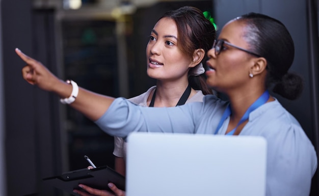 Server maintenance and people programming technology or IT technician with teamwork Datacenter repair or problem solving to fix error or check system hardware in inspection with laptop or solution