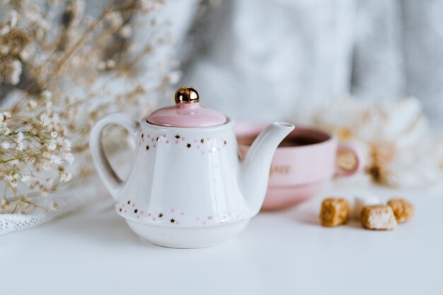 Servizio da tè, teiera con cubetti di zucchero e una tazza con tè preparato