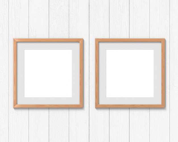 Set di 2 mockup di cornici quadrate in legno con un bordo appeso al muro. Spazio vuoto per foto o testo. Rendering 3D.