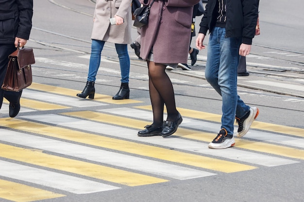 Sezione bassa di persone che camminano sulla strada