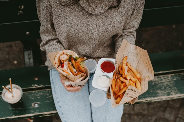Sezione centrale di donne che tengono il cibo in piedi in un'area pubblica