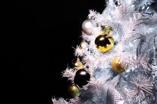 Sfere lucide di natale in oro e argento sull'albero di natale con spazio per il testo