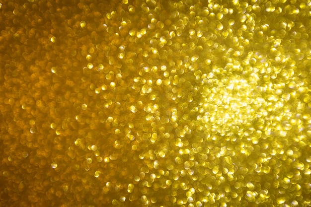 Sfocatura dello sfondo di Natale festivo con glitter oro astratto con luce bokeh