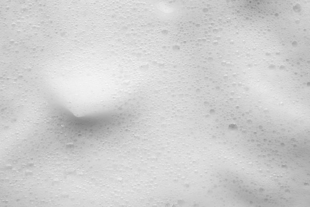 Sfondamento di consistenza delle bolle di schiuma di sapone bianco astratto