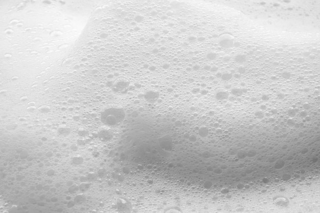Sfondamento di consistenza delle bolle di schiuma di sapone bianco astratto