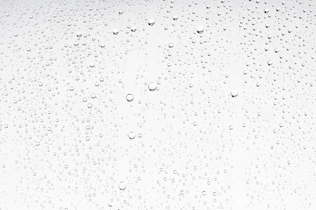 sfondo bianco isolato gocce d'acqua sul vetro / vetro della finestra bagnato con spruzzi e gocce d'acqua e calce, trama autunnale sfondo