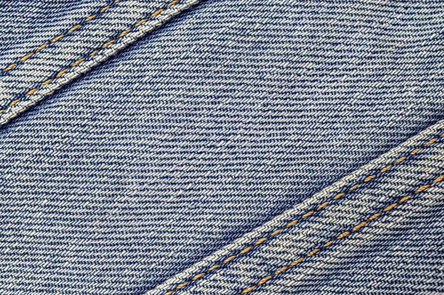 Sfondo blu denim con strisce diagonali con punti di sutura