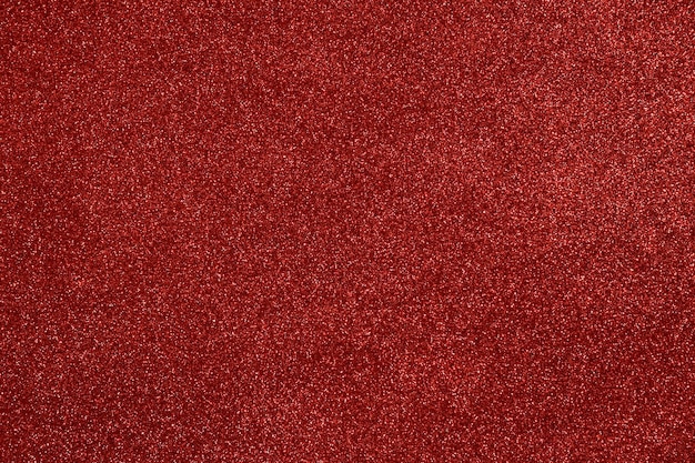 Sfondo da foamiran glitter rosso con una curva. Bokeh brillante. Decorazione festiva.